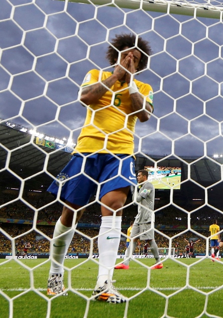 Brazil's Marcelo reacts after conceding their fifth goal to Germany during their 2014 World Cup semi-finals at the Mineirao stadium in Belo Horizonte July 8, 2014. REUTERS/Eddie Keogh (BRAZIL - Tags: SOCCER SPORT WORLD CUP)