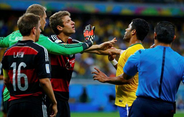 Germany's Thomas Mueller (3rd L) argues with Brazil's Hulk (2nd L) beside teammates Philipp Lahm (L), Manuel Neuer and referee Marco Rodriguez of Mexico (R) during their 2014 World Cup semi-finals at the Mineirao stadium in Belo Horizonte July 8, 2014. REUTERS/Damir Sagolj (BRAZIL - Tags: SOCCER SPORT WORLD CUP TPX IMAGES OF THE DAY)