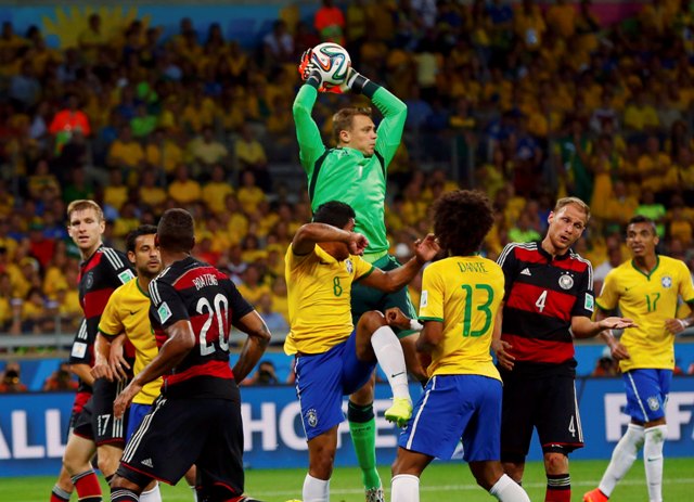 Germany's Manuel Neuer (C, top) makes a save during a Brazil corner kick in their 2014 World Cup semi-finals at the Mineirao stadium in Belo Horizonte July 8, 2014. REUTERS/Eddie Keogh (BRAZIL - Tags: SOCCER SPORT WORLD CUP)