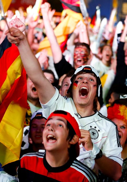 People celebrate after Germany scored against Brazil during their 2014 World Cup semi-finals, at the Fanmeile public viewing arena in Berlin July 8, 2014. REUTERS/Thomas Peter (GERMANY - Tags: SPORT SOCCER WORLD CUP)
