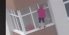 فيديو.. سيدة تجازف بحياتها لتنظيف نافذة