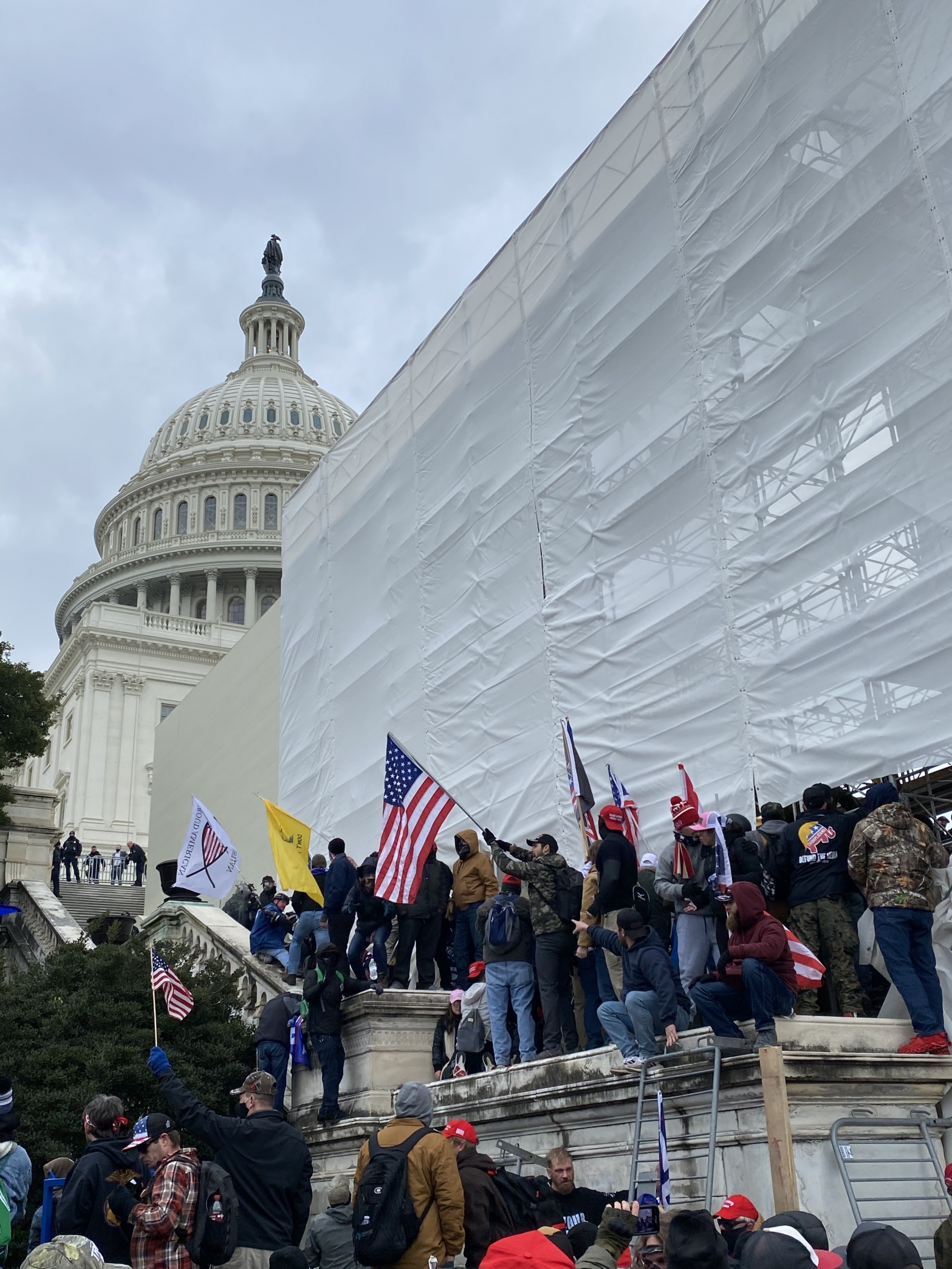 متظاهرون ينزلون العلم الأمريكي من فوق مقر الكونجرس