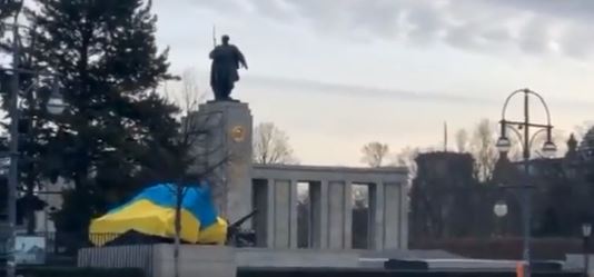 شاهد.. محتجون ألمان يغطون دبابة سوفيتية بالعلم الأوكراني