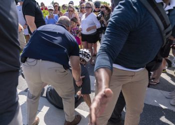 President Joe Biden is helped by U.S. Secret Service agents after he fell trying to get off his bike to greet a crowd on a trail at Gordons Pond in Rehoboth Beach, Del., Saturday, June 18, 2022. (AP Photo/Manuel Balce Ceneta)