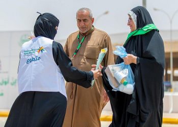متطوعة وأبناؤها في خدمة الحجاج في منفذ جديدة عرعر - المواطن
