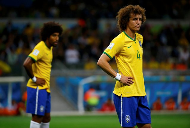 Brazil's David Luiz (R) reacts near teammate Dante during their 2014 World Cup semi-finals against Germany at the Mineirao stadium in Belo Horizonte July 8, 2014. REUTERS/Damir Sagolj (BRAZIL - Tags: SOCCER SPORT WORLD CUP)