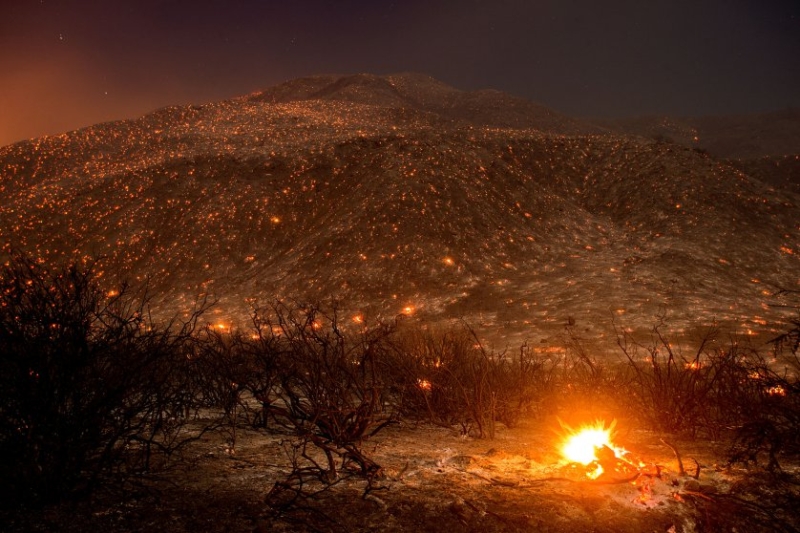 Embers from a wildfire smolder along Lytle Creek Road near Keenbrook, Calif., on Aug. 17, 2016. Firefighters had at least established a foothold of control of the blaze the day after it broke out for unknown reasons in the Cajon Pass near Interstate 15, the vital artery between Los Angeles and Las Vegas. Five years of drought have turned the state's wild lands into a tinderbox.