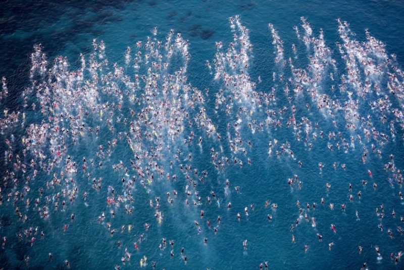 Athletes compete in the swim portion of the 2016 IRONMAN World Championship triathlon in Kailua Kona, Hawaii, on Oct. 8, 2016.
