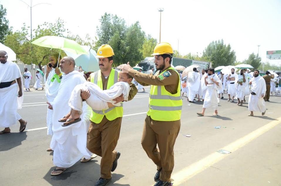 صورة متداولة.. رجلا أمن يحملان طفلاً ويحميانه من أشعة الشمس