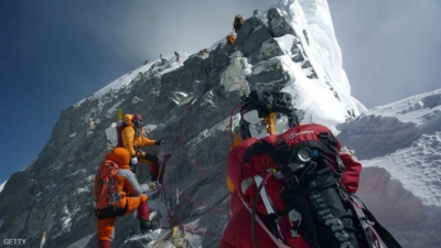 FILE TO GO WITH Nepal-Everest-environment-climbing, FOCUS by Deepesh Shrestha (FILES) In this May 19, 2009 file photograph, unidentified mountaineers walk past the Hillary Step while pushing for the summit of Mount Everest as they climb the south face from Nepal. A group of top Nepalese climbers is planning a high-risk expedition to clean up Everest, saying decades of mountaineering have taken their toll on the world's highest peak. "Everest is losing her beauty," seven times Everest summitteer Namgyal Sherpa, 30, told AFP. "The top of the mountain is now littered with oxygen bottles, old prayer flags, ropes, and old tents. At least two dead bodies have been lying there for years now." AFP PHOTO/COURTESY OF PEMBA DORJE SHERPA (Photo credit should read STR/AFP/Getty Images)