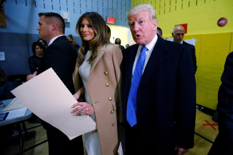 Republican presidential nominee Donald Trump and wife Melania Trump walk with their ballots to the scanner after voting at PS 59 in New York, New York, U.S. November 8, 2016. REUTERS/Carlo Allegri